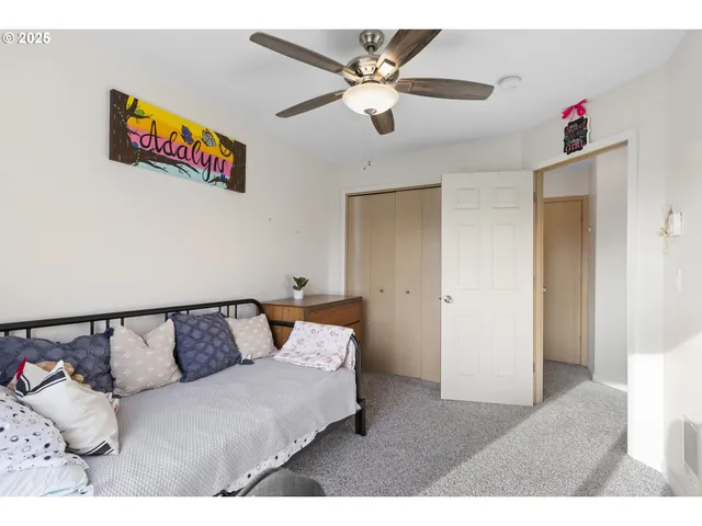 a living room with furniture and a ceiling fan