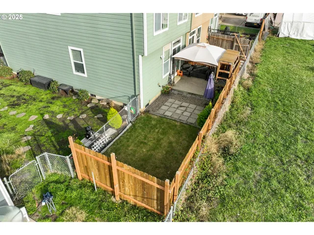 a view of a backyard with sitting area