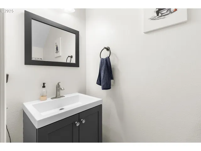 a bathroom with a sink mirror and vanity