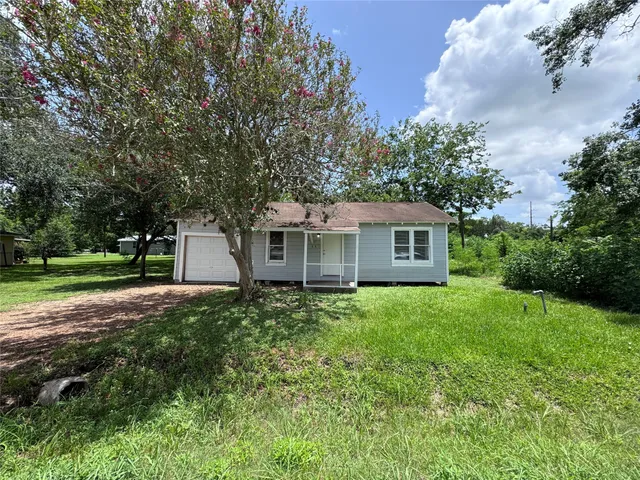 a view of a house with yard and a garden