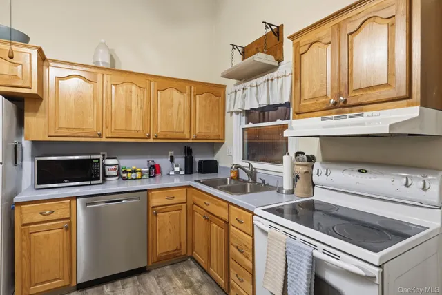 a kitchen with stainless steel appliances a stove a sink and a microwave