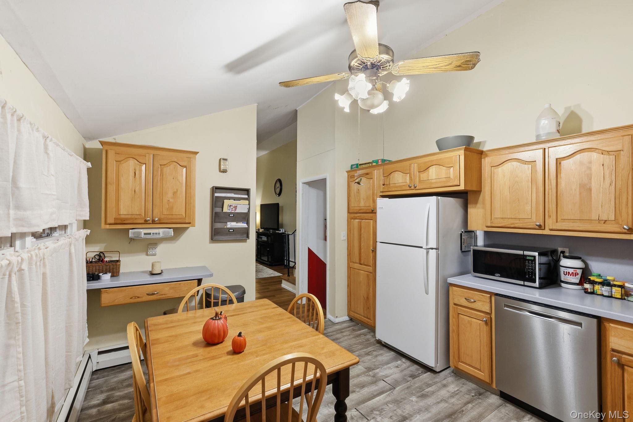 6 Liss Road Wappingers Falls, NY 12590 - Photo 10 of 28 a kitchen with stainless steel appliances granite countertop a refrigerator a sink dishwasher a stove with wooden cabinets and floor