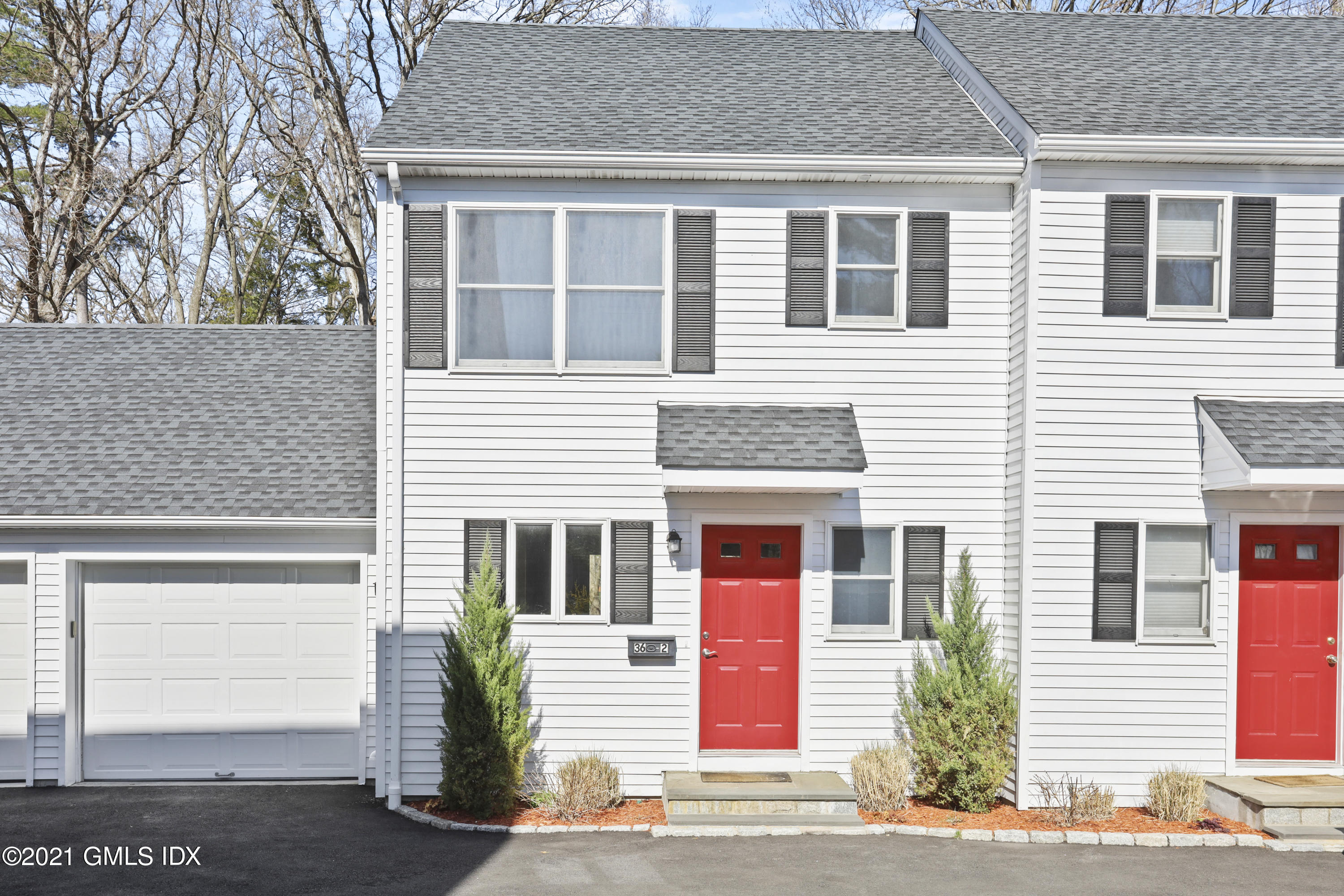 36 Decatur Street, Unit 2 Cos Cob, CT 06807 - Photo 1 of 30 a front view of a house with a yard and garage
