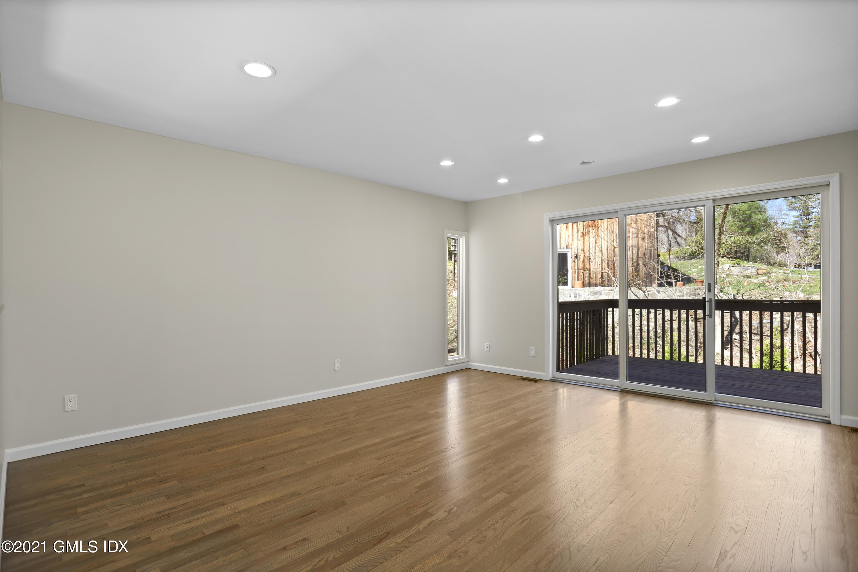 36 Decatur Street, Unit 2 Cos Cob, CT 06807 - Photo 11 of 30 an empty room with wooden floor and windows