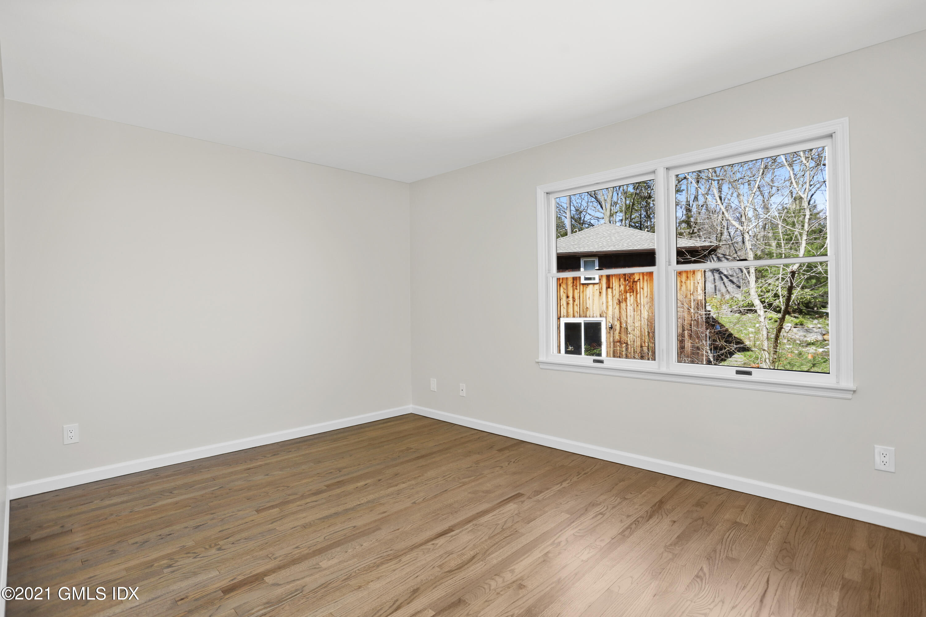 36 Decatur Street, Unit 2 Cos Cob, CT 06807 - Photo 16 of 30 a view of an empty room with wooden floor and a window