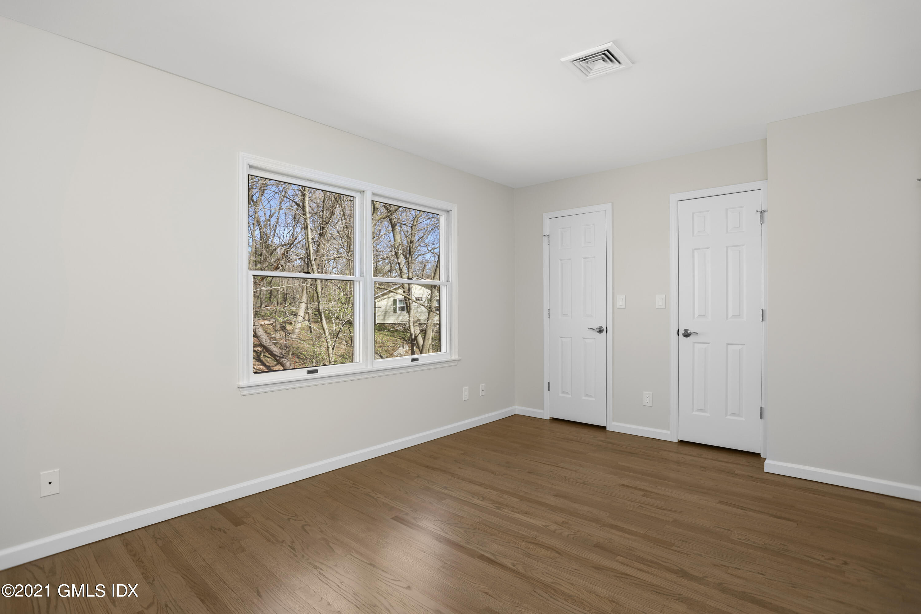 36 Decatur Street, Unit 2 Cos Cob, CT 06807 - Photo 17 of 30 an empty room with wooden floor and windows