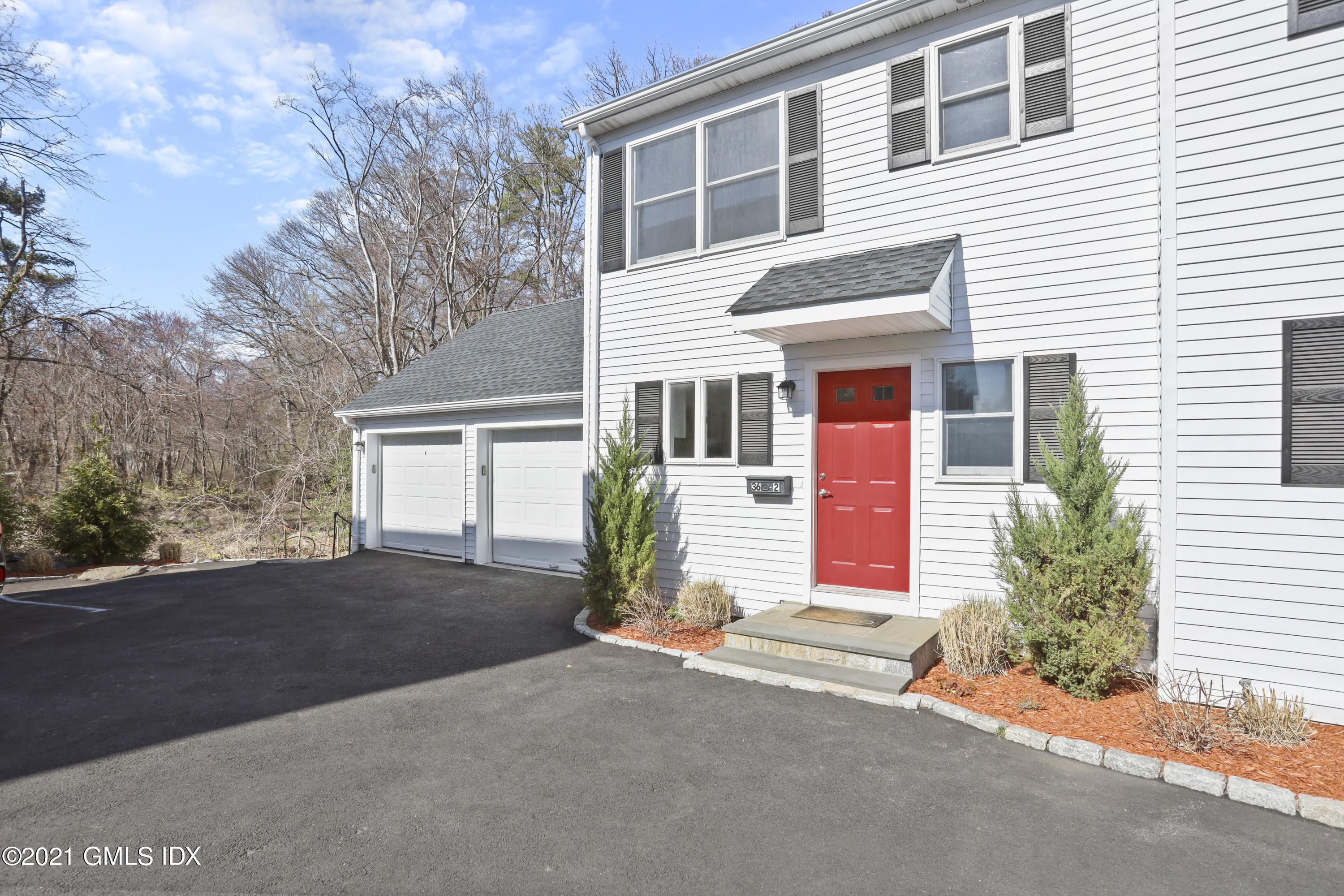 36 Decatur Street, Unit 2 Cos Cob, CT 06807 - Photo 2 of 30 a front view of a house with a yard and garage