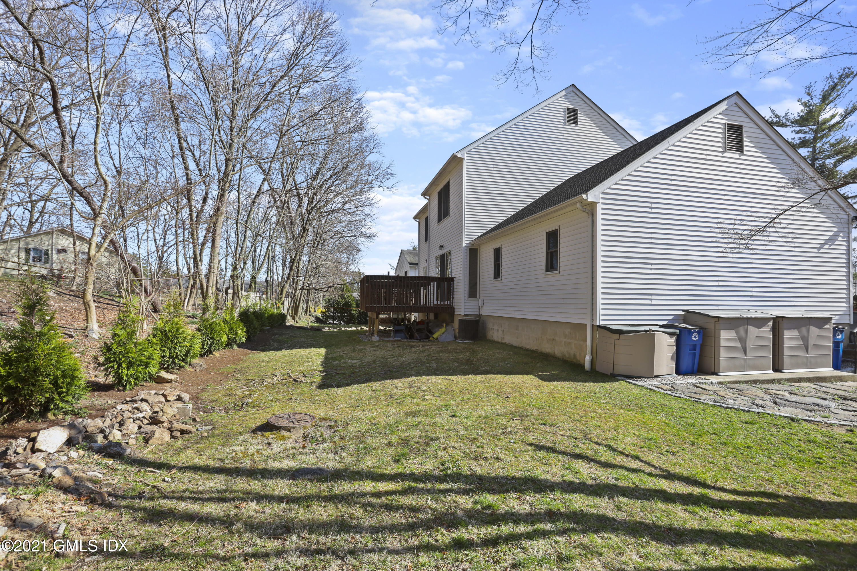 36 Decatur Street, Unit 2 Cos Cob, CT 06807 - Photo 27 of 30 a view of a house with a yard covered in snow