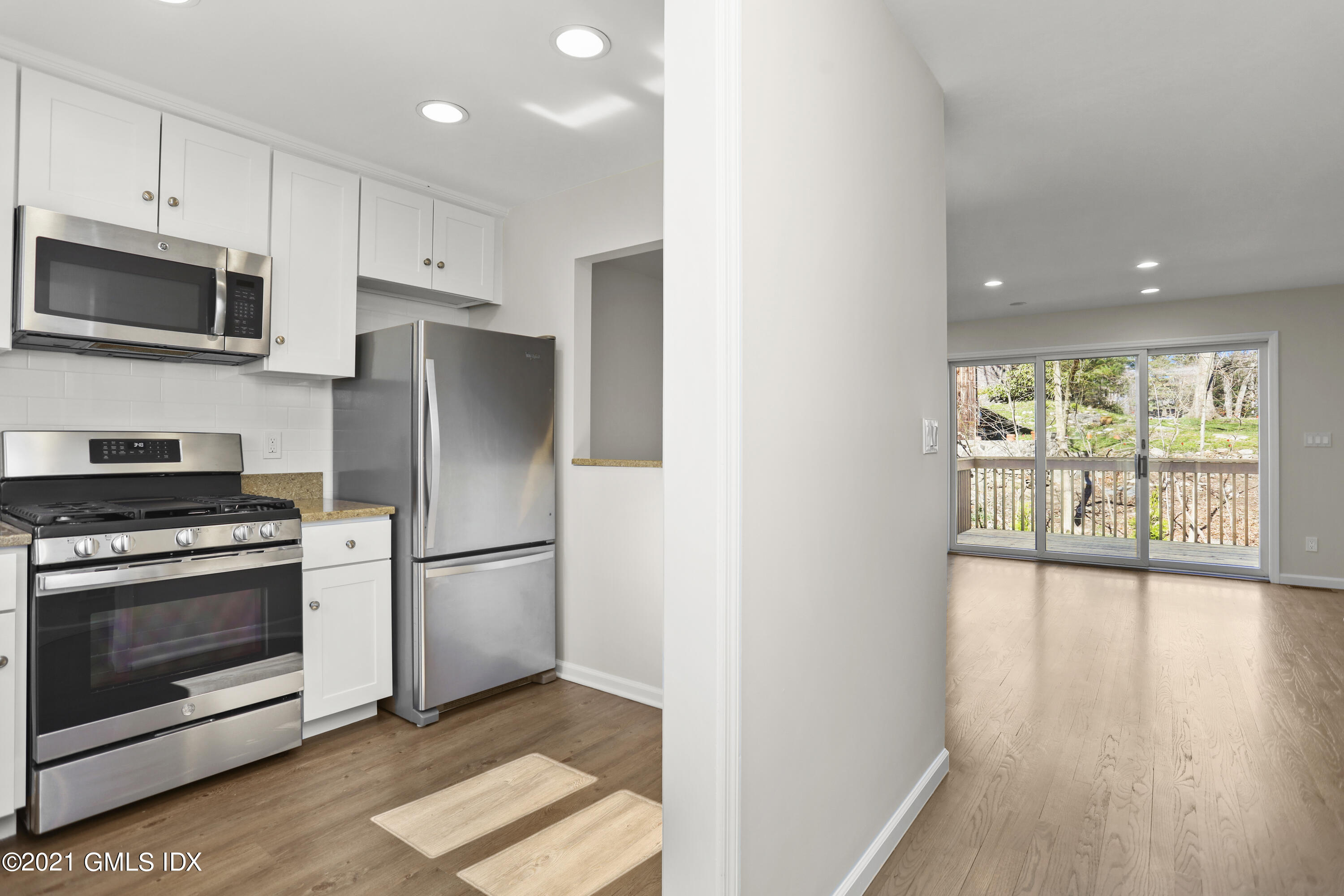 36 Decatur Street, Unit 2 Cos Cob, CT 06807 - Photo 5 of 30 a kitchen with stainless steel appliances granite countertop a refrigerator microwave and stove top oven