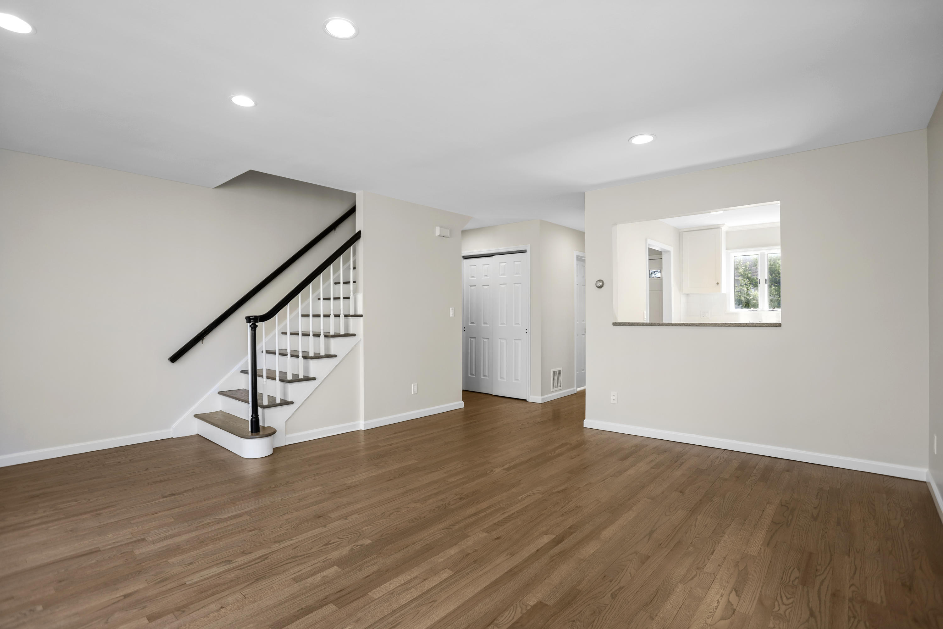 36 Decatur Street, Unit 2 Cos Cob, CT 06807 - Photo 10 of 30 a view of an empty room with wooden floor and stairs