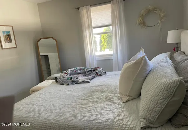 a bedroom with a bed and a fireplace