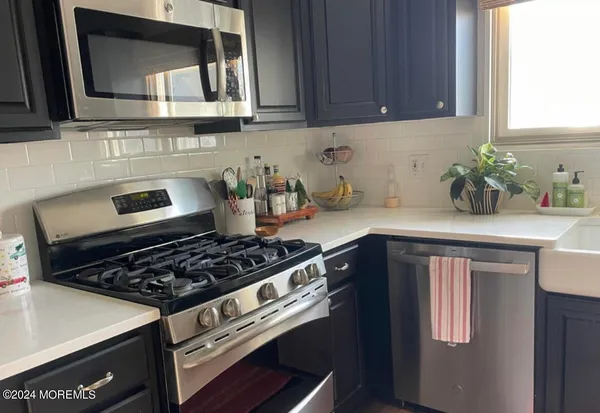 a kitchen with metallic refrigerator freezer and a dishwasher