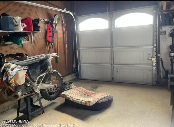 a view of a chair and table in backyard of the house