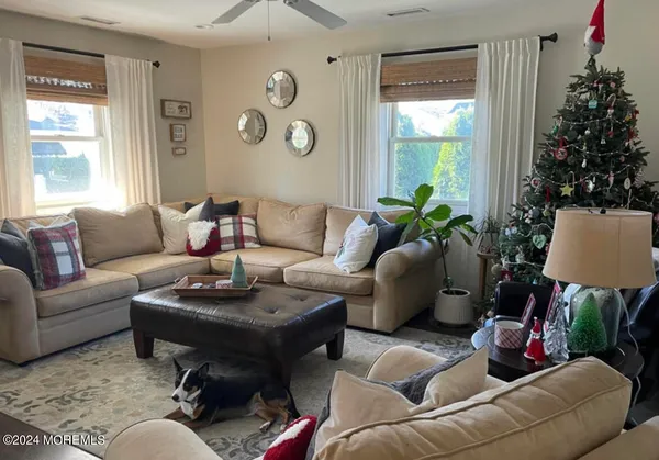 a living room with furniture and a chandelier