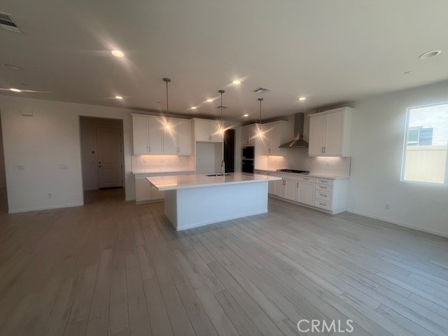 24309 Arroyo Drive Menifee, CA 92584 - Photo 7 of 19 a view of a kitchen with kitchen island wooden floor and stainless steel appliances