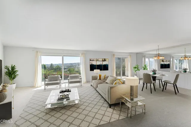 a living room with furniture a flat screen tv and a large window