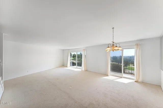 a view of an empty room with windows