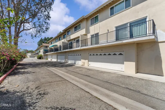 a front view of a building with a yard
