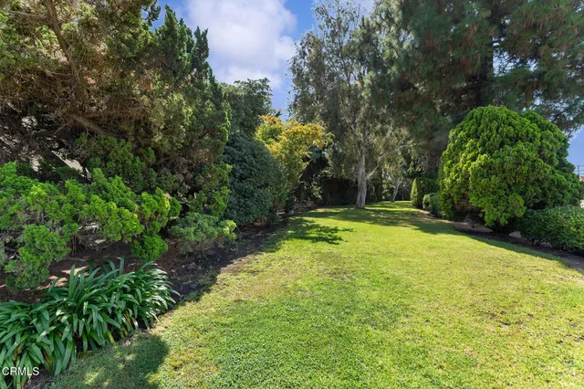 a swimming pool with outdoor seating and yard