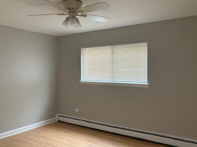 8923 Knight Avenue, Unit 201 Des Plaines, IL 60016 - Photo 11 of 13 an empty room with a window and a fan