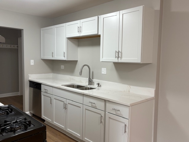 8923 Knight Avenue, Unit 201 Des Plaines, IL 60016 - Photo 3 of 13 a kitchen with white cabinets and a stove with wooden floors