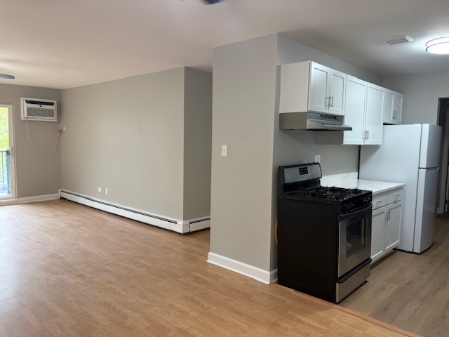 8923 Knight Avenue, Unit 201 Des Plaines, IL 60016 - Photo 5 of 13 a kitchen with stainless steel appliances a stove a refrigerator and cabinets