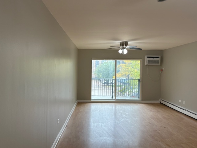 8923 Knight Avenue, Unit 201 Des Plaines, IL 60016 - Photo 6 of 13 an empty room with wooden floor and windows with curtains