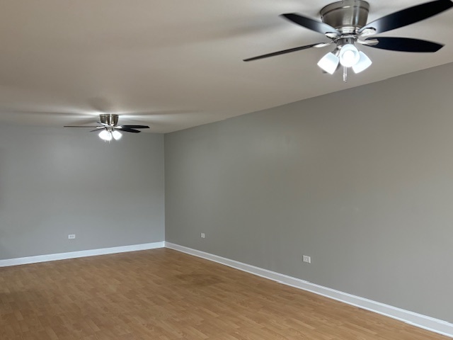 8923 Knight Avenue, Unit 201 Des Plaines, IL 60016 - Photo 8 of 13 an empty room with a window and a fan