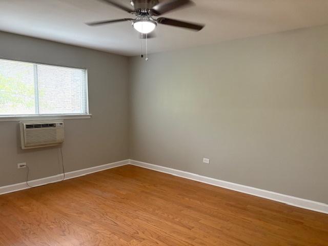 8923 Knight Avenue, Unit 201 Des Plaines, IL 60016 - Photo 9 of 13 an empty room with a window and ceiling fan