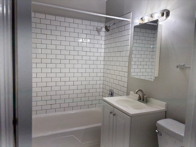 8923 Knight Avenue, Unit 201 Des Plaines, IL 60016 - Photo 10 of 13 a bathroom with a sink a toilet and shower