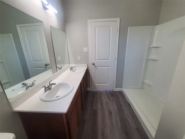 a bathroom with a sink a mirror and a toilet