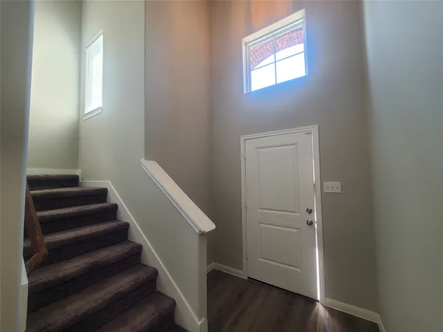 a view of entryway with wooden floor and stairs