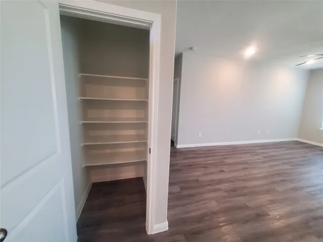 a view of walk in closet with empty racks