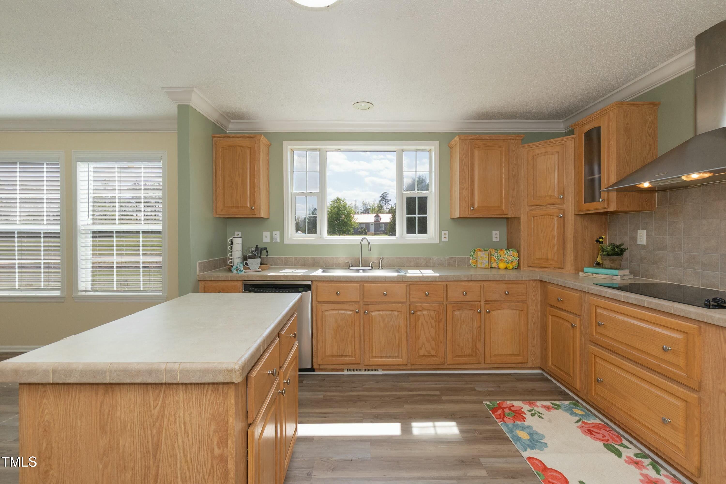 660 Our Way Linden, NC 28356 - Photo 11 of 36 a kitchen with stainless steel appliances granite countertop a sink stove and cabinets