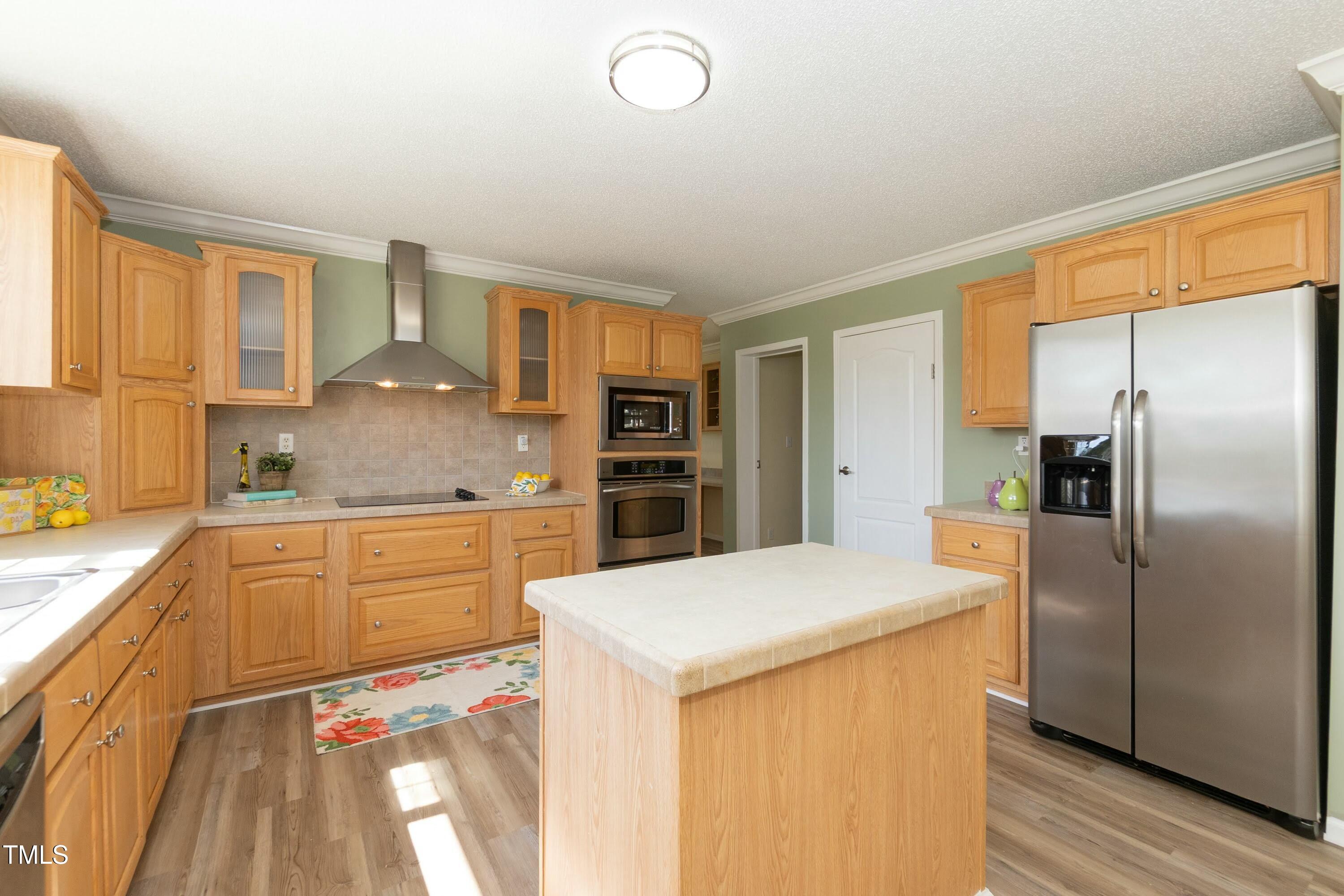 660 Our Way Linden, NC 28356 - Photo 13 of 36 a kitchen with stainless steel appliances a refrigerator sink and cabinets