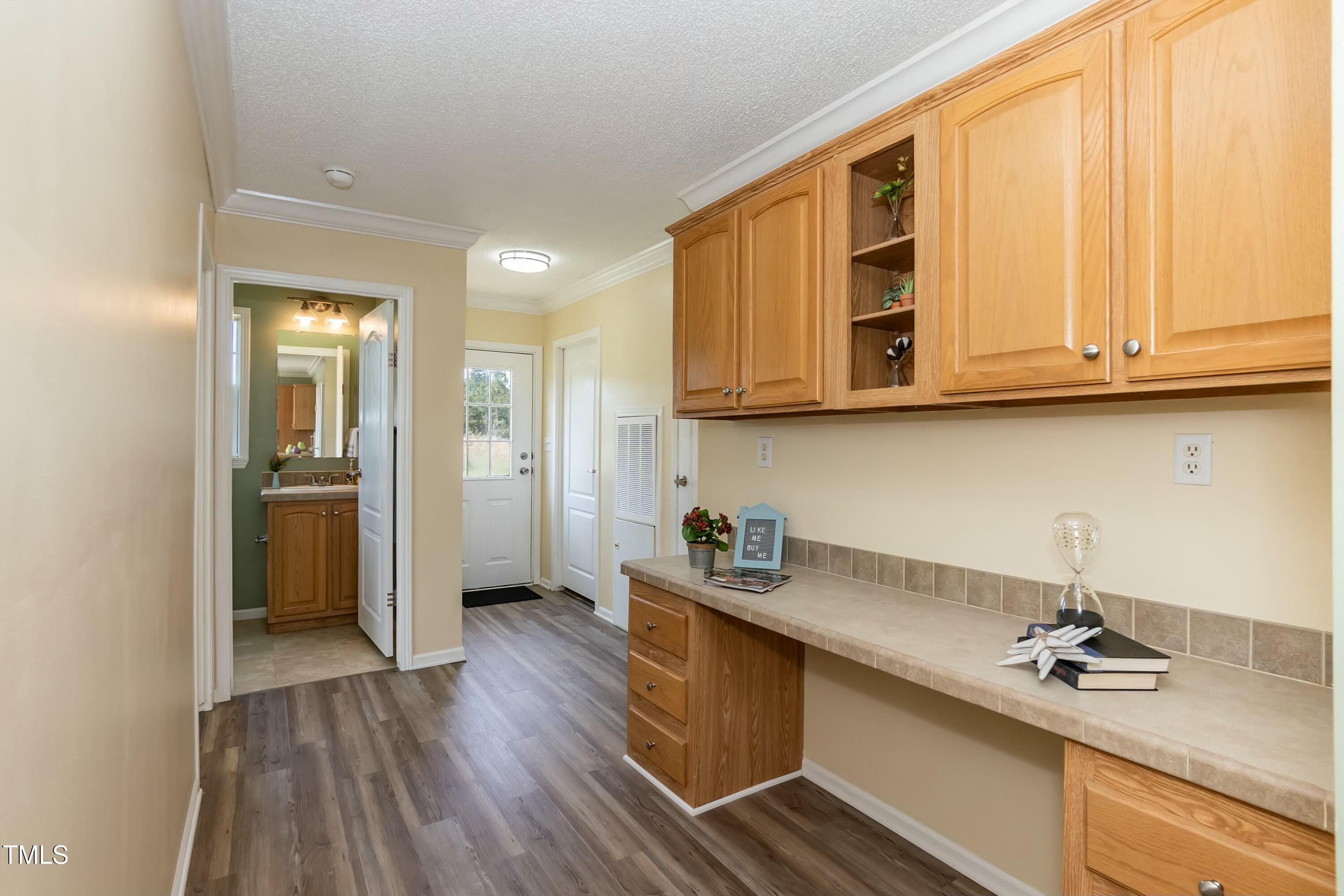 660 Our Way Linden, NC 28356 - Photo 15 of 36 a kitchen with stainless steel appliances granite countertop a sink dishwasher a refrigerator and cabinets with wooden floor