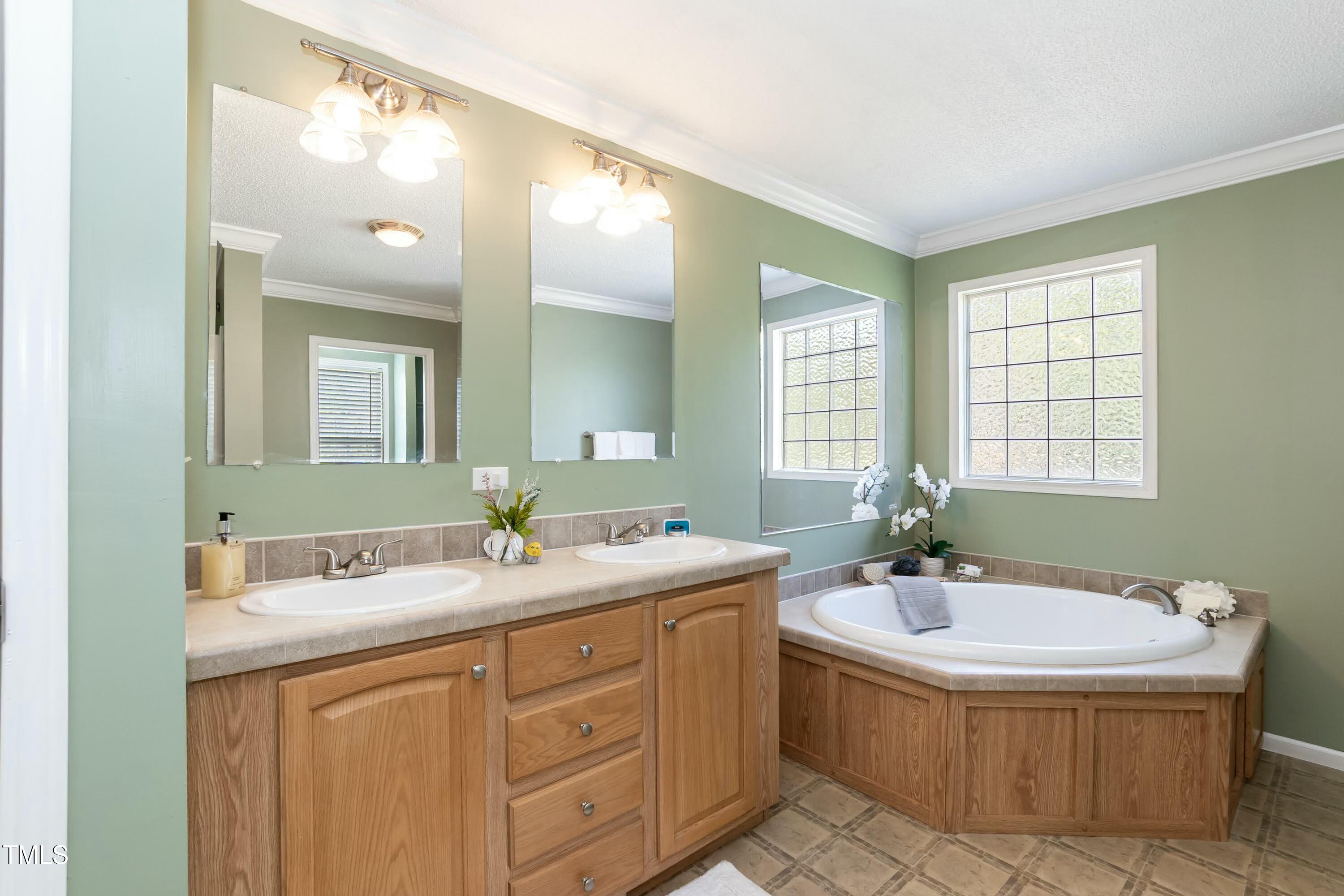 660 Our Way Linden, NC 28356 - Photo 19 of 36 a bathroom with a sink double vanity and a mirror
