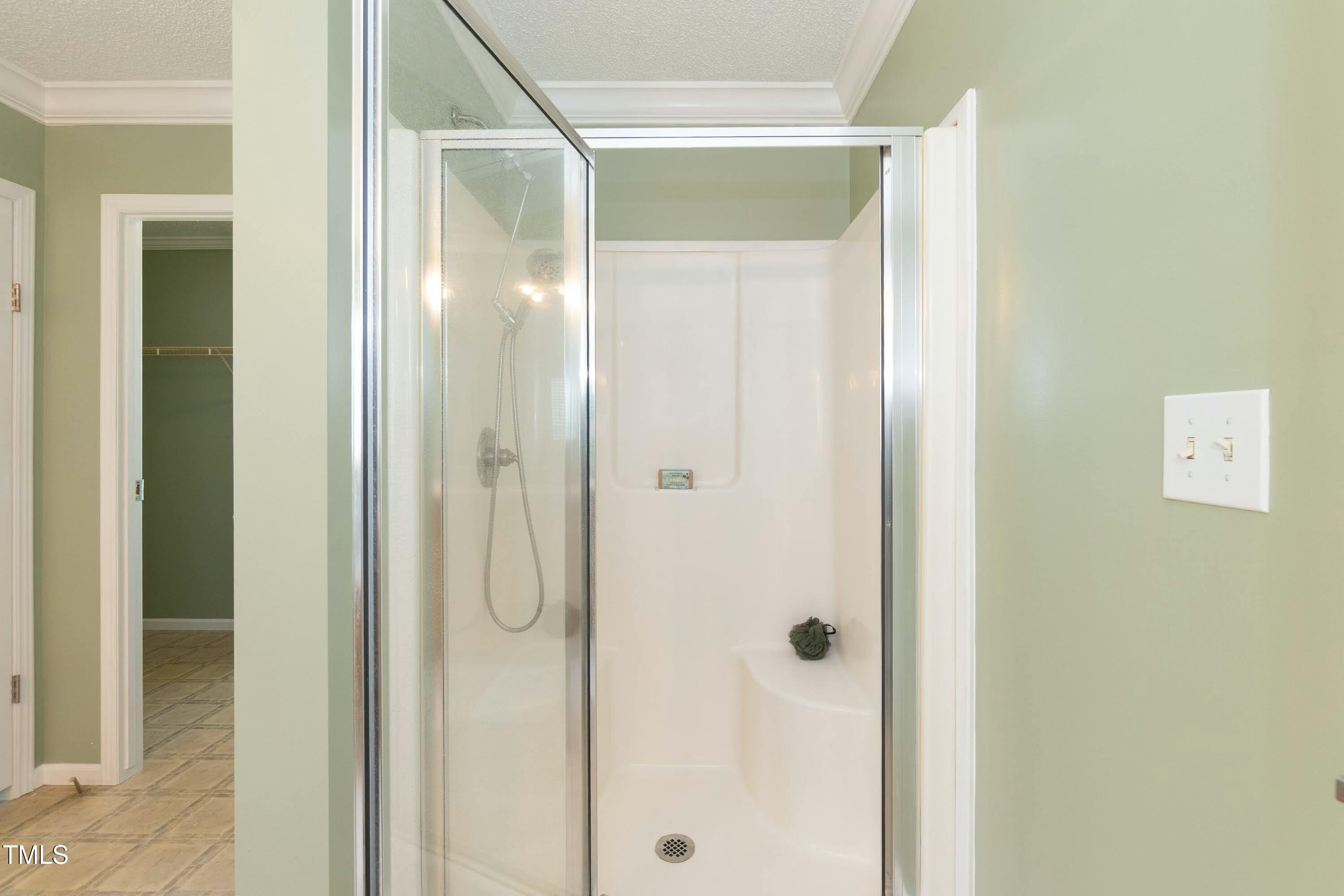 660 Our Way Linden, NC 28356 - Photo 20 of 36 a bathroom with a glass shower door