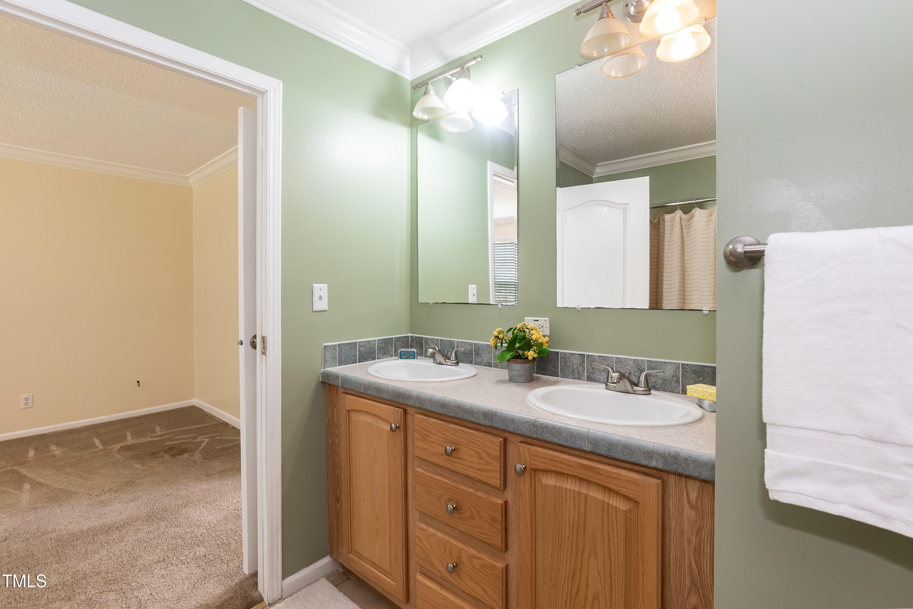 660 Our Way Linden, NC 28356 - Photo 25 of 36 a bathroom with a sink and a mirror