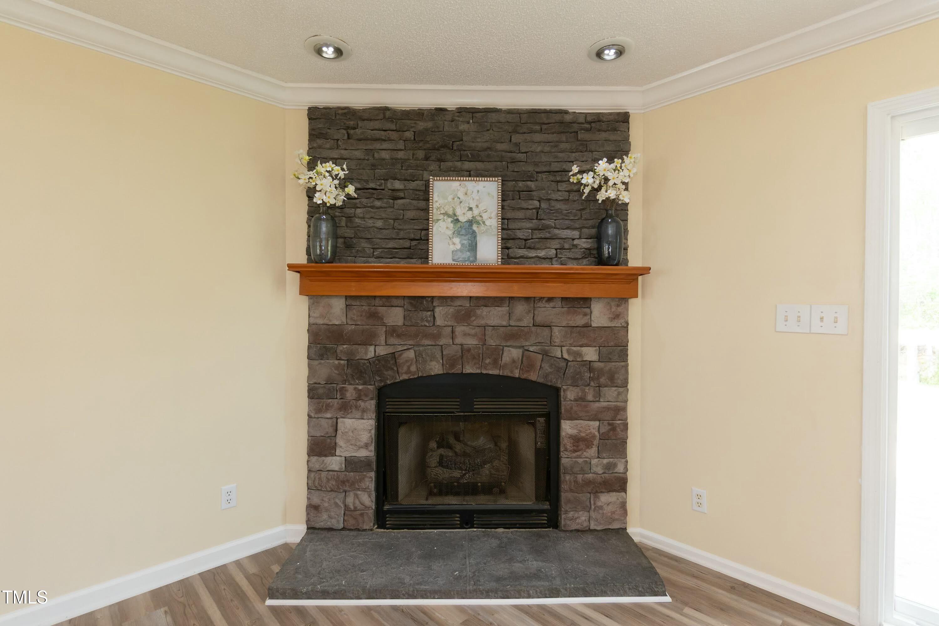 660 Our Way Linden, NC 28356 - Photo 8 of 36 a stone house with a fireplace in it