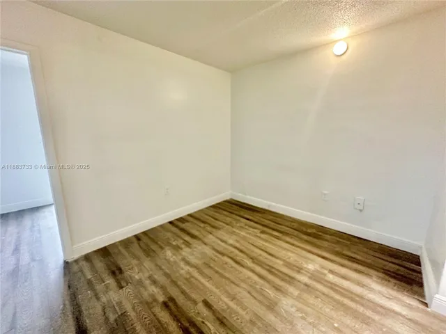 a kitchen with a sink a stove and cabinets