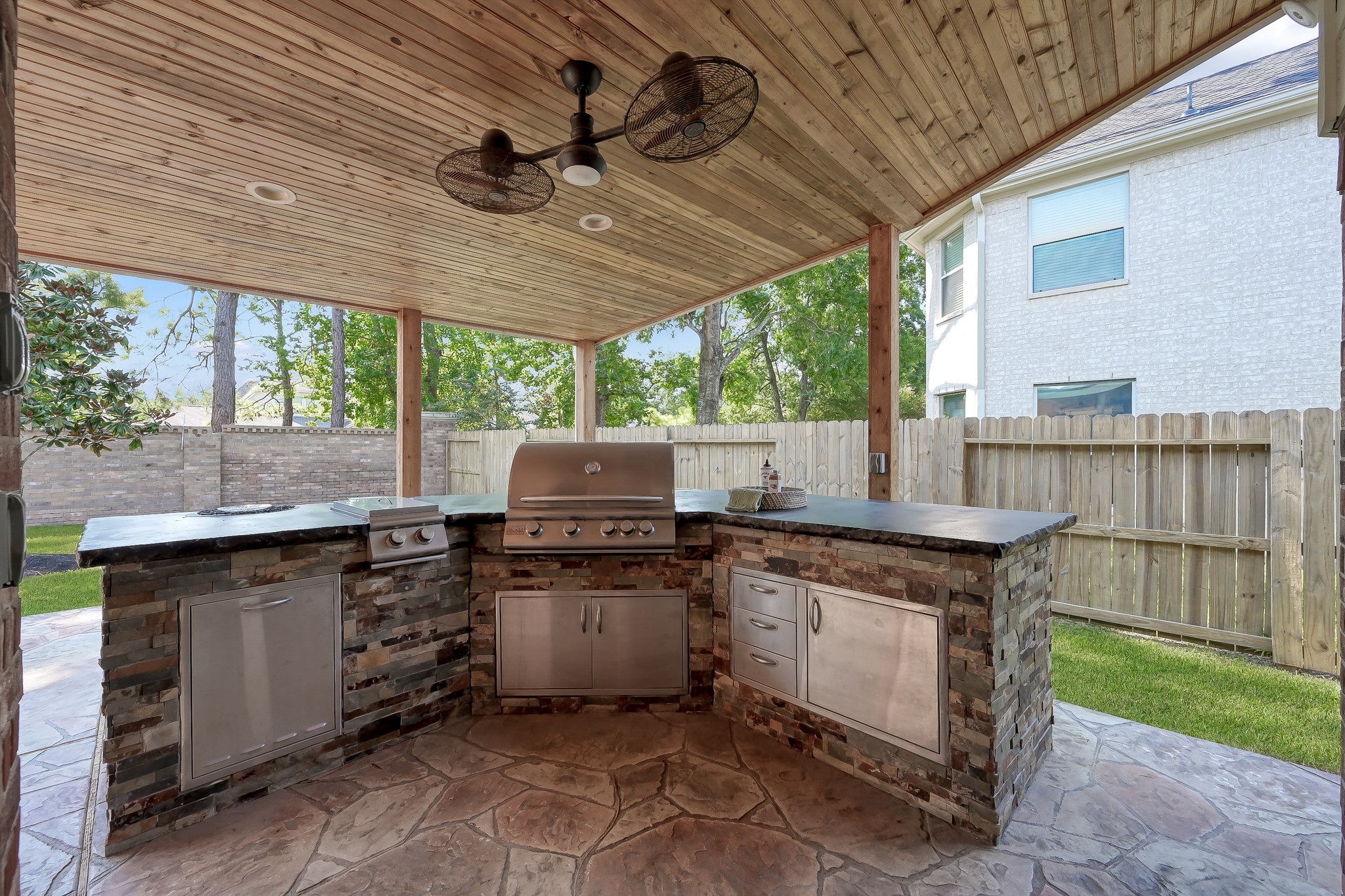 14730 Ramblebrook Humble, TX 77396 - Photo 6 of 48 a kitchen with stainless steel appliances granite countertop a stove a sink dishwasher and a microwave oven with cabinets