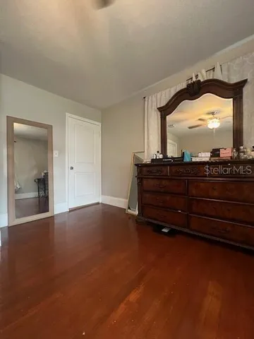 a room with a bed and a mirror