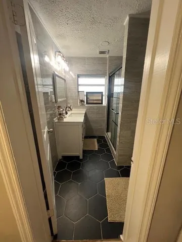 a bathroom with a sink and mirror