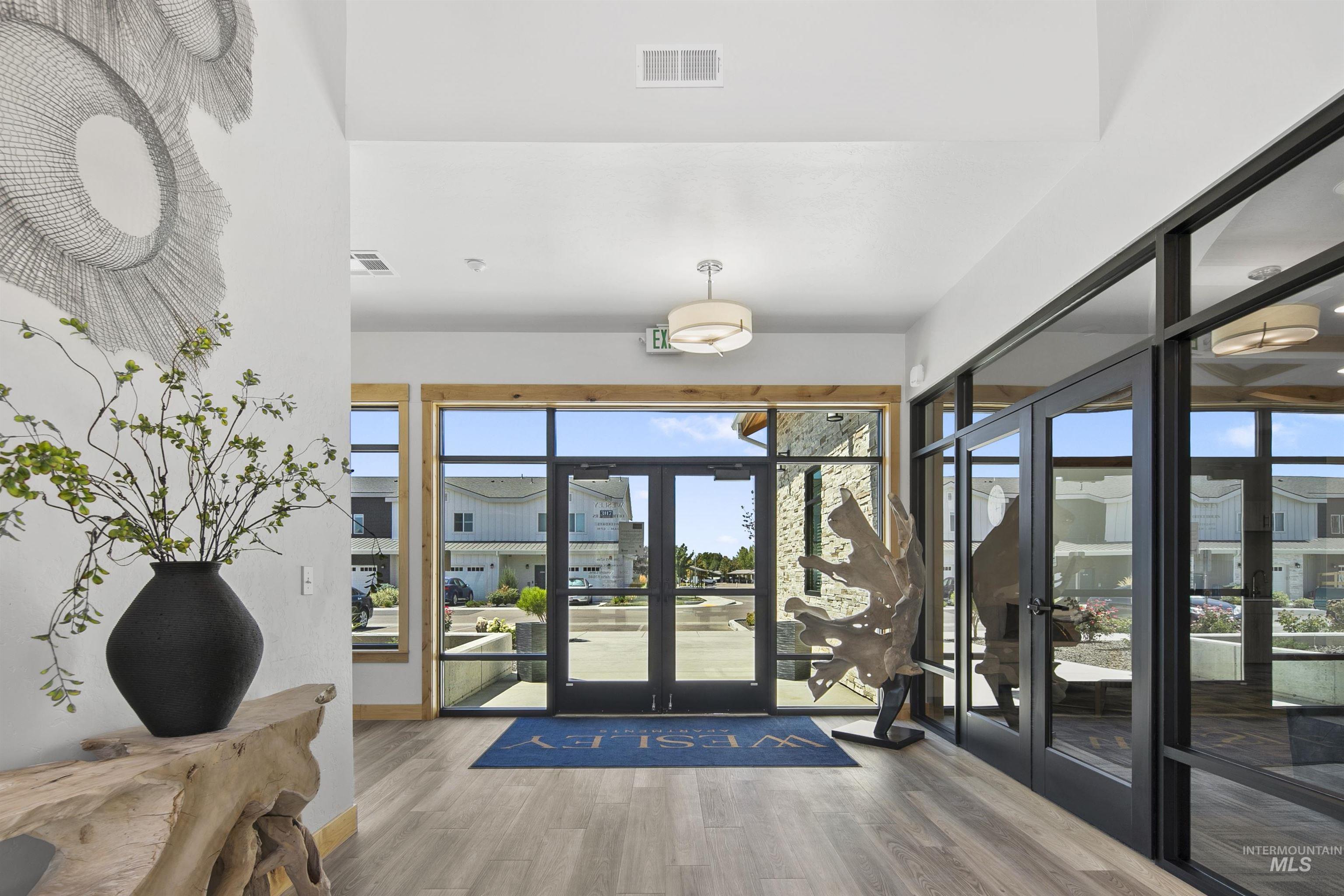 665 West Wrangler Street Meridian, ID 83646 - Photo 17 of 18 Lobby entry featuring large windows, wood-finish flooring, recessed lighting, and modern pendant fixtures