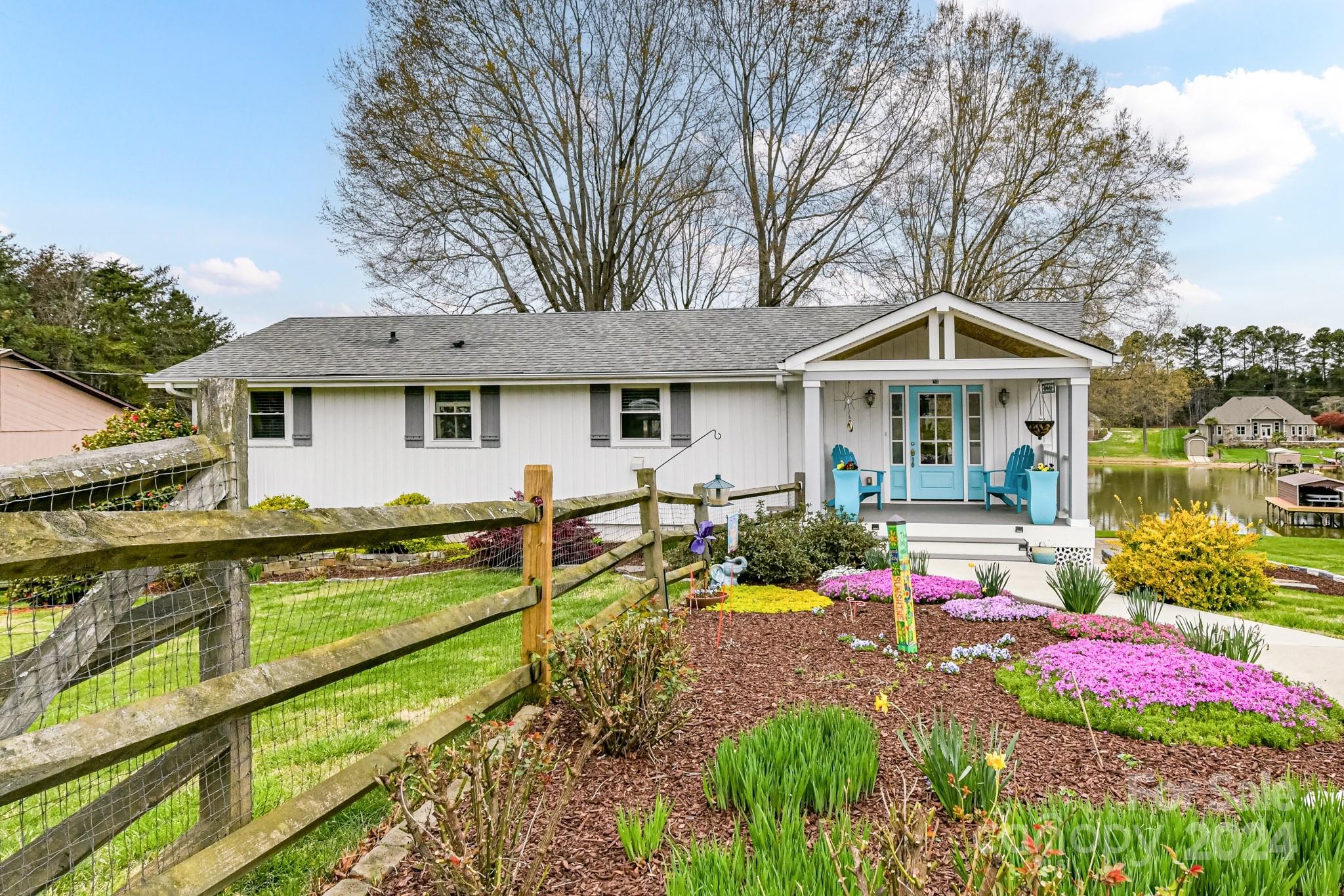 a front view of a house with swimming pool and porch