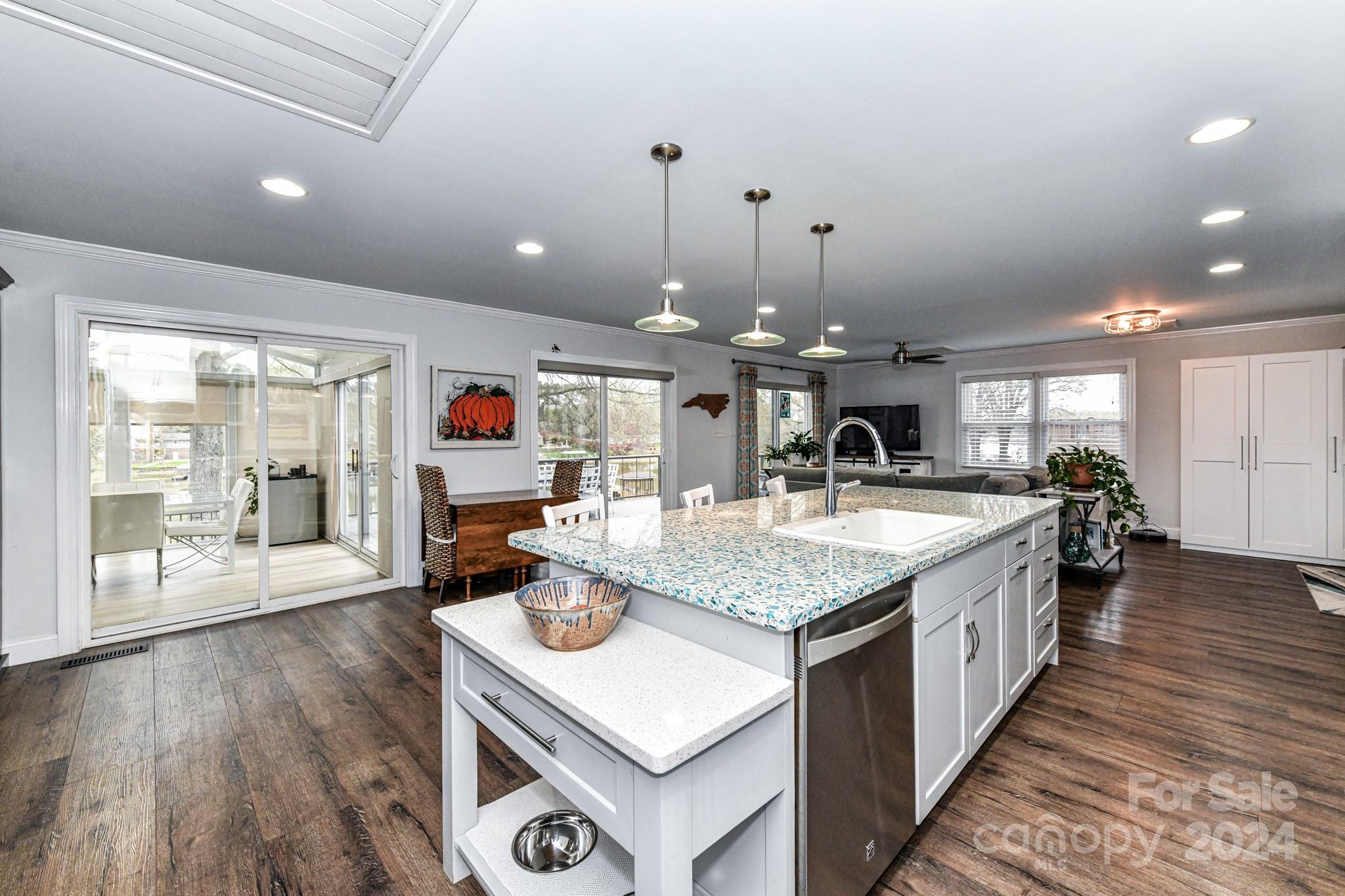 334 Ervin Road Mooresville, NC 28117 - Photo 11 of 48 a kitchen with stainless steel appliances granite countertop a sink stove and wooden floor