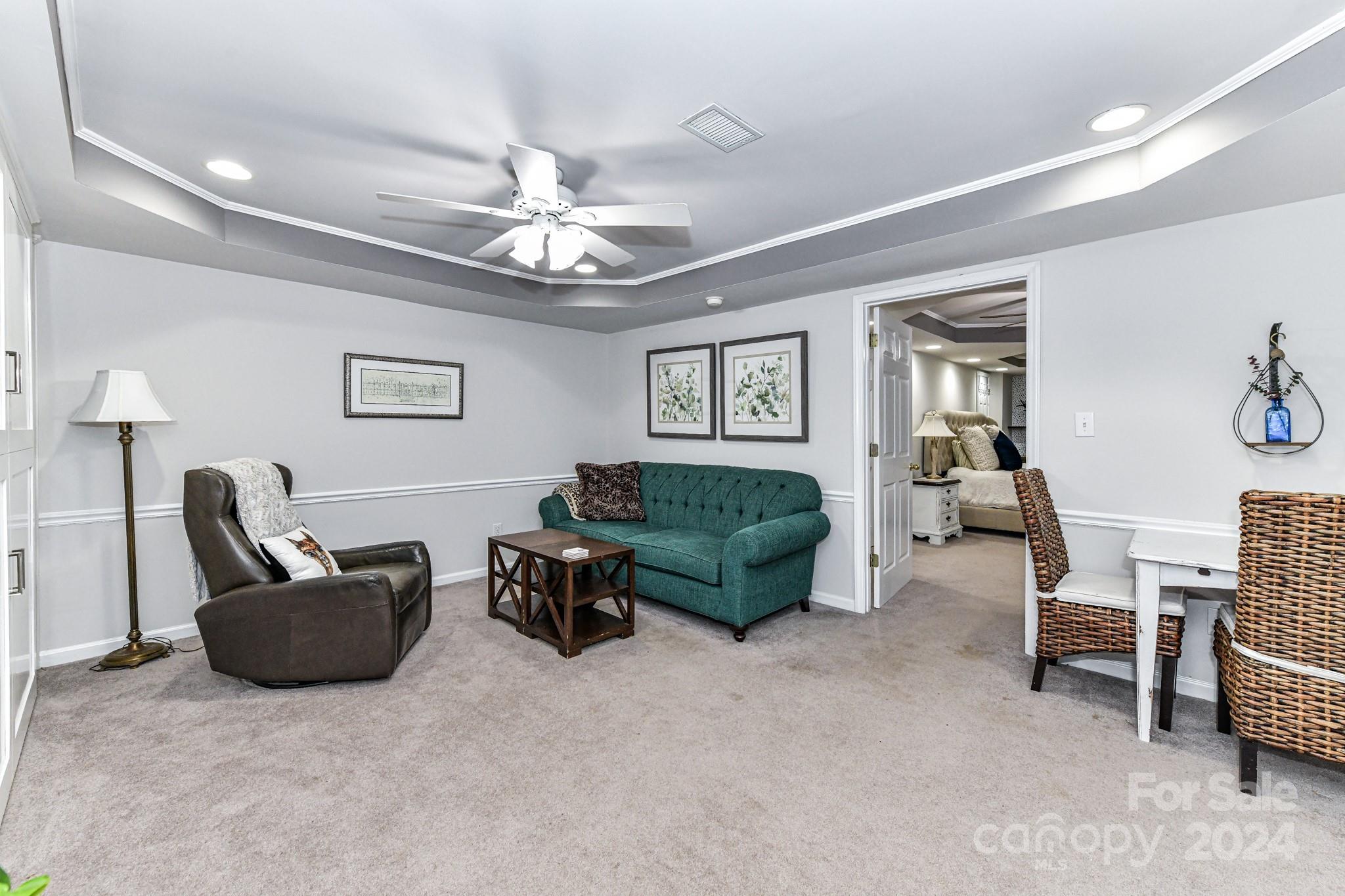 334 Ervin Road Mooresville, NC 28117 - Photo 22 of 48 a living room with furniture and a chandelier
