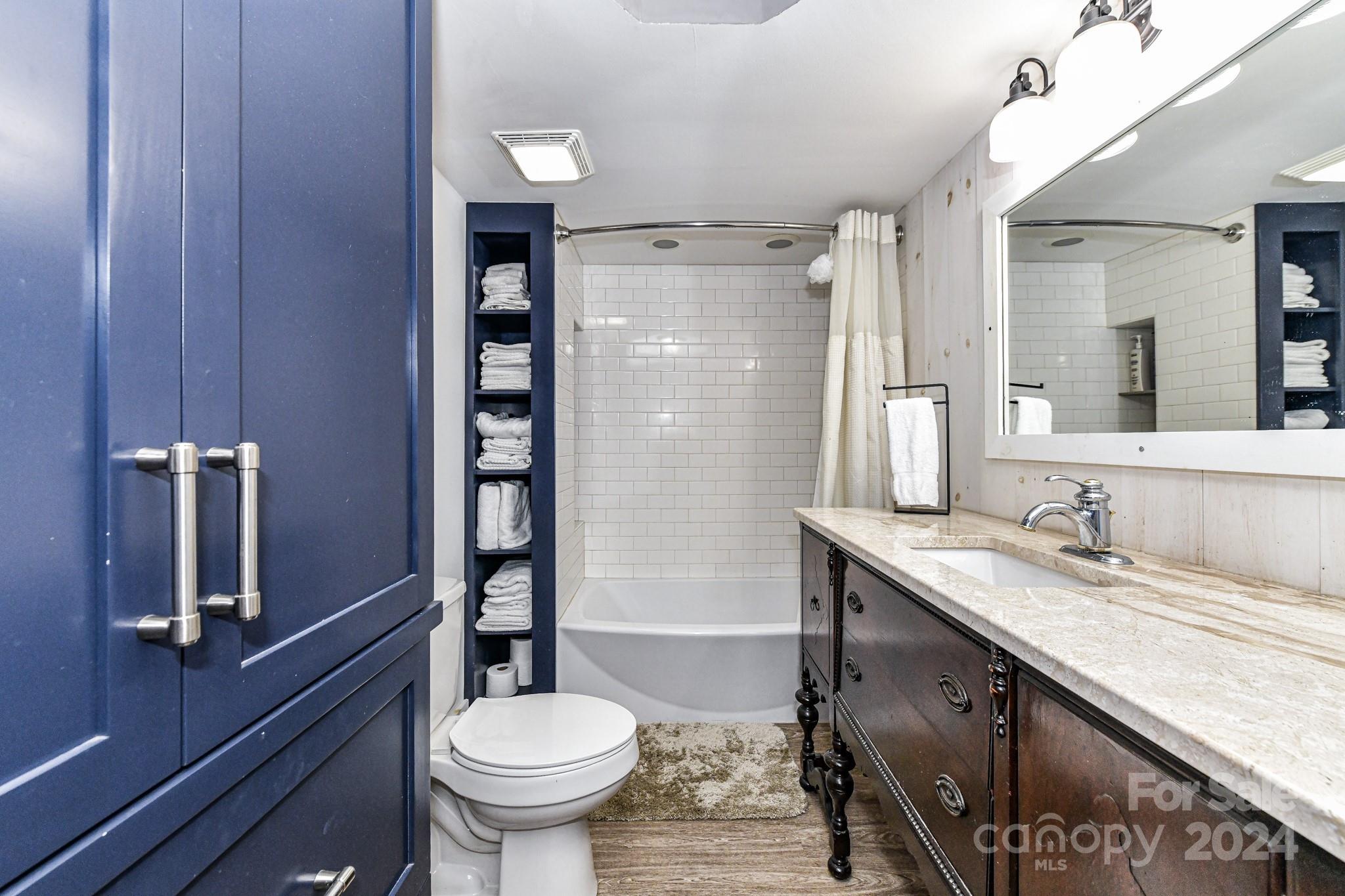 334 Ervin Road Mooresville, NC 28117 - Photo 25 of 48 a bathroom with a granite countertop sink toilet a mirror and shower