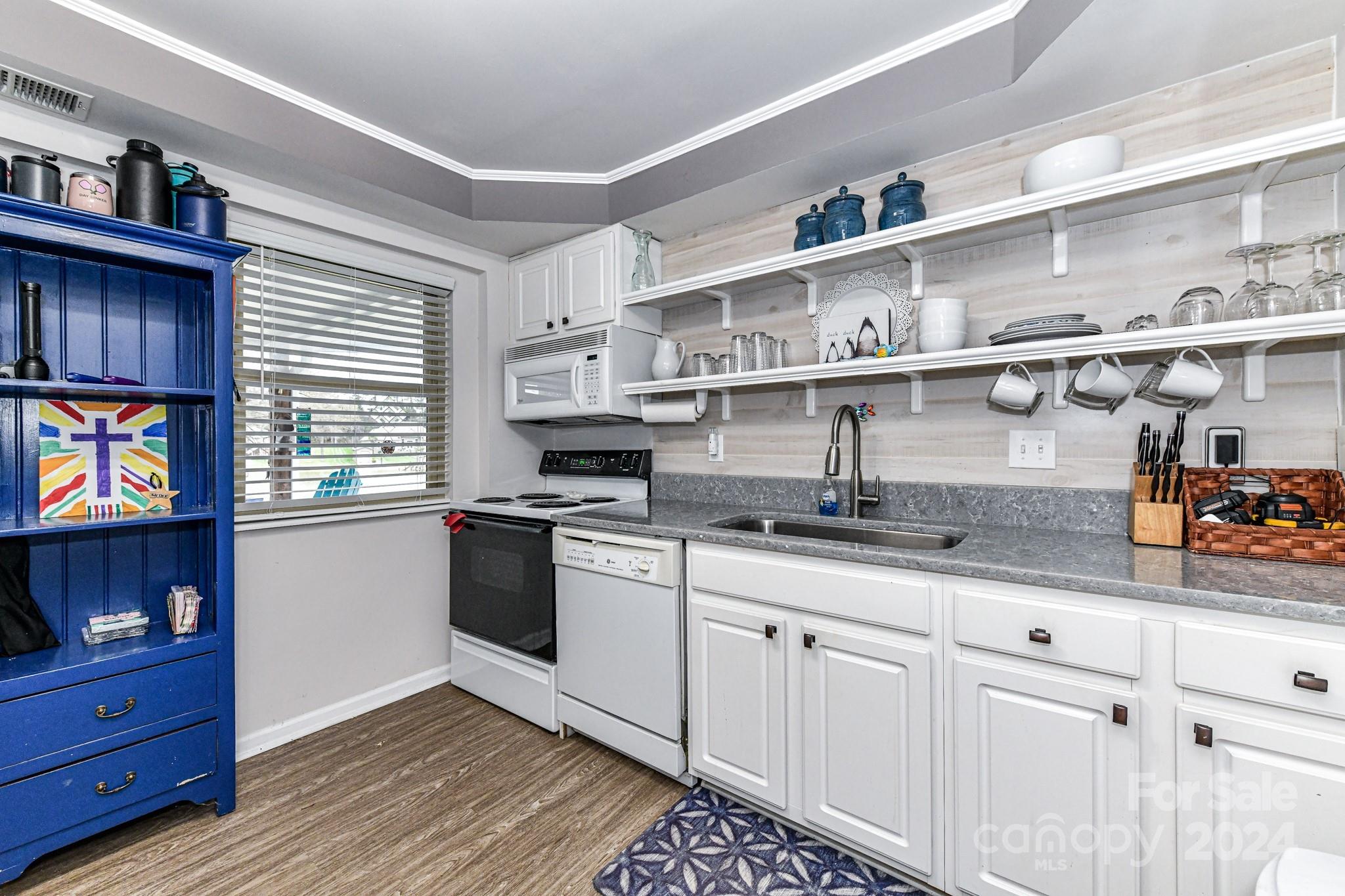 334 Ervin Road Mooresville, NC 28117 - Photo 27 of 48 a kitchen with stainless steel appliances granite countertop a sink a stove and cabinets
